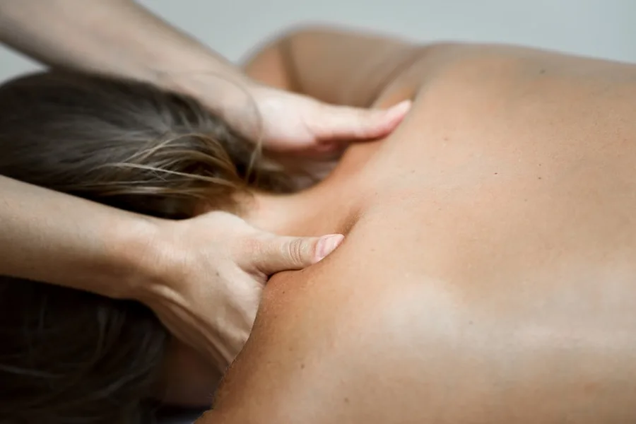 Chiropractor Springfield Illinois young woman receiving back massage spa center